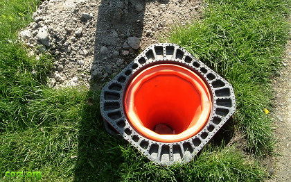 a road-works cone embedded upside-down in the ground
